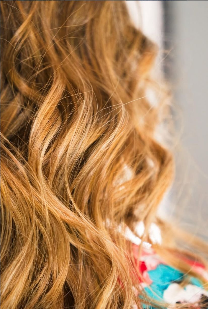 Warm golden balayage on long wavy hair